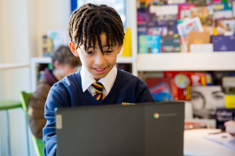 Child using laptop at Christleton High School