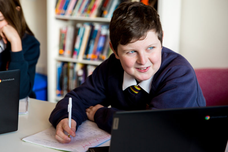 High school boy in library